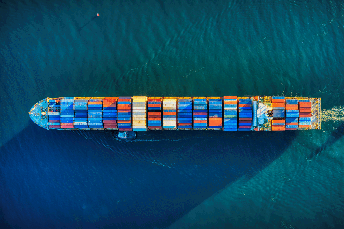 Aerial view of a container ship carrying cargo, representing supply chain and logistics
